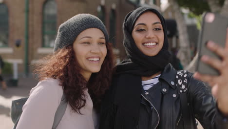 portrait-of-two-young-woman-friends-close-up-of-multi-ethnic-girlfriends-posing-making-faces-taking-selfie-photo-using-smartphone