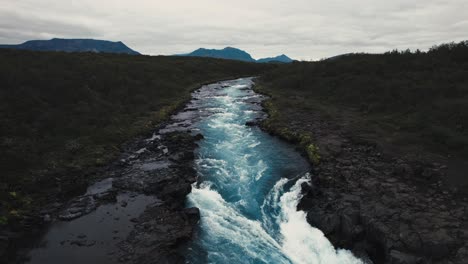 aerial clear blue waterfall river hlauptungufoss iceland, beautiful moody icelandic landscape