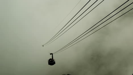 iconic table mountain cable car emerges from thick cloud, cape town