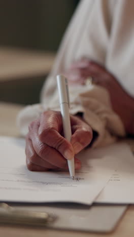 close up of a woman signing a document