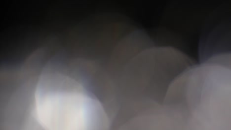 abstract silver colored bokeh, defocus round, circle on black background