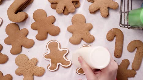 decorating gingerbread cookies with royal icing for christmas.