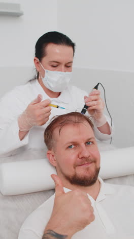 trichologist doing man improve hair growth procedure dermapen microneedling vitamin injections