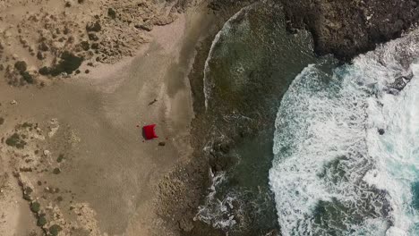 drone flies above lagoon with tent fhd