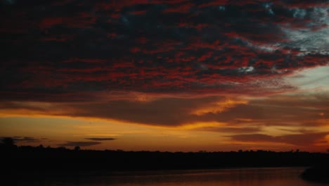 dramatic sky with vibrant clouds at twilight over african river