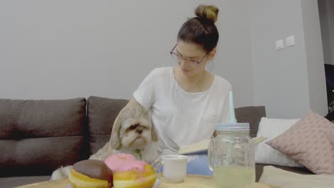 young woman with cute dog at home