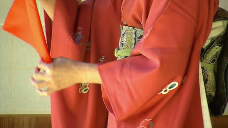 Close-up-of-a-Japanese-woman's-hands-as-she-practices-using-a-fukusa,-the-cloth-used-in-the-Japanese-tea-ceremony