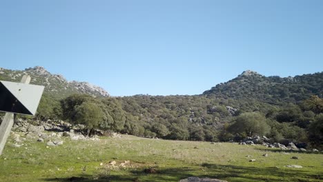 Intensive-Hunting-Reserve-black-and-white-diagonal-sign-in-Sierra-de-Cadiz,-Passing-Tracking-Shot