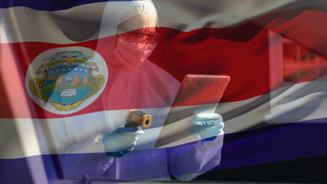 costa rican flag waving male scientist with temperature gun using digital tablet