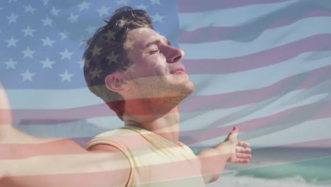 Animation-of-flag-of-united-states-of-america-over-happy-caucasian-man-on-beach