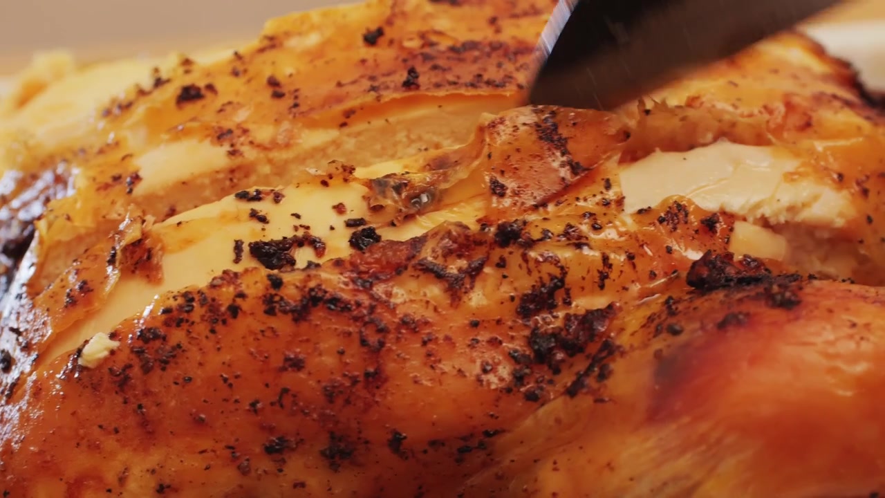 Slicing a Golden Brown Roasted Chicken Breast