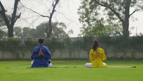 Reverse-Namaste-Yoga-being-performed-by-an-Indian-couple