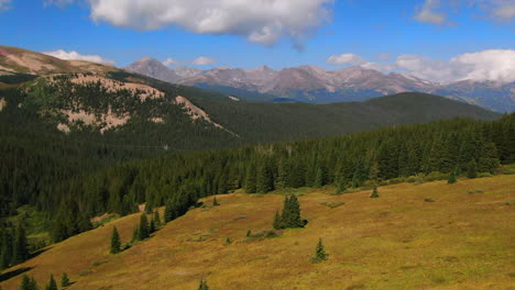 colorful colorado cinematic aerial drone summer boreas pass breckenridge summit county power lines green grass dramatic incredible landscape rocky mountain peaks daylight forward reveal up motion