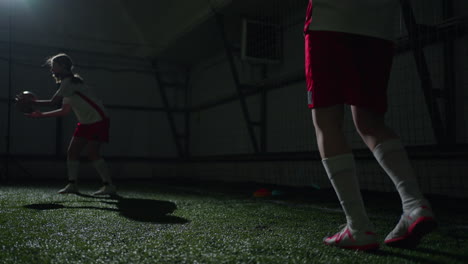 two female soccer players training indoors