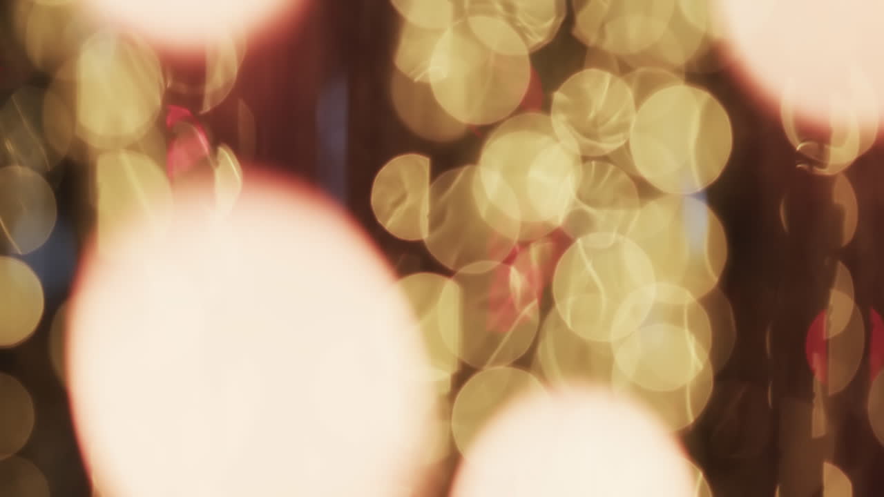 Video of flickering yellow bokeh spots of light with copy space