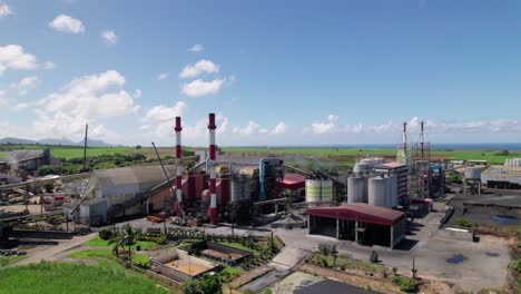 a bustling cement factory in mauritius with clear skies, aerial view