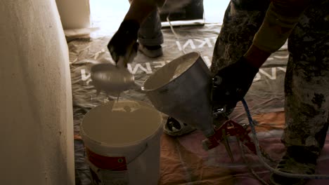 painting a room with a spray gun