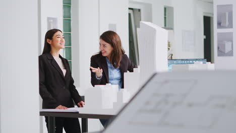 Architects-doing-high-five-gesture-after-finishing-blueprints