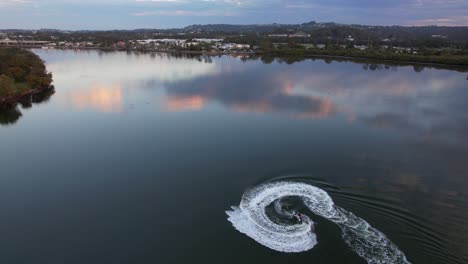 aerial view of jetskier, jetskiing in the maroochy river in qld, australia