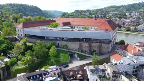 aerial view of schlossmuseum linz perched above the danube river in linz, austria. linz, austria