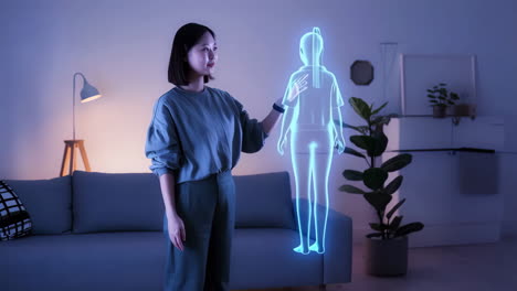 woman interacting with holographic human figure in a living room