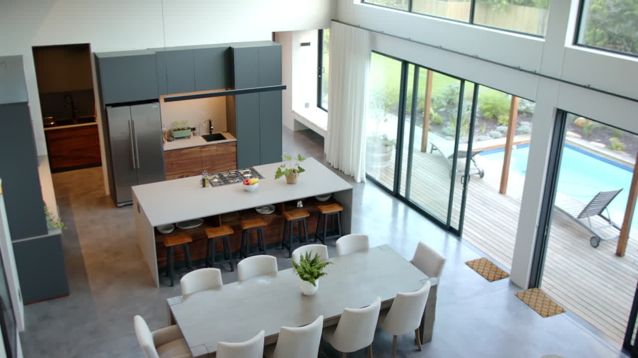 Modern kitchen and dining area with large table and stylish chairs, copy space
