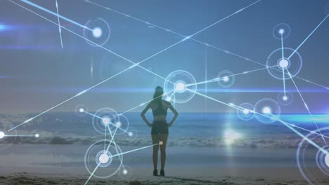 animation of networks of connections over caucasian woman praciticing yoga on beach