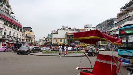 vehicles and pedestrians crossing a busy city square