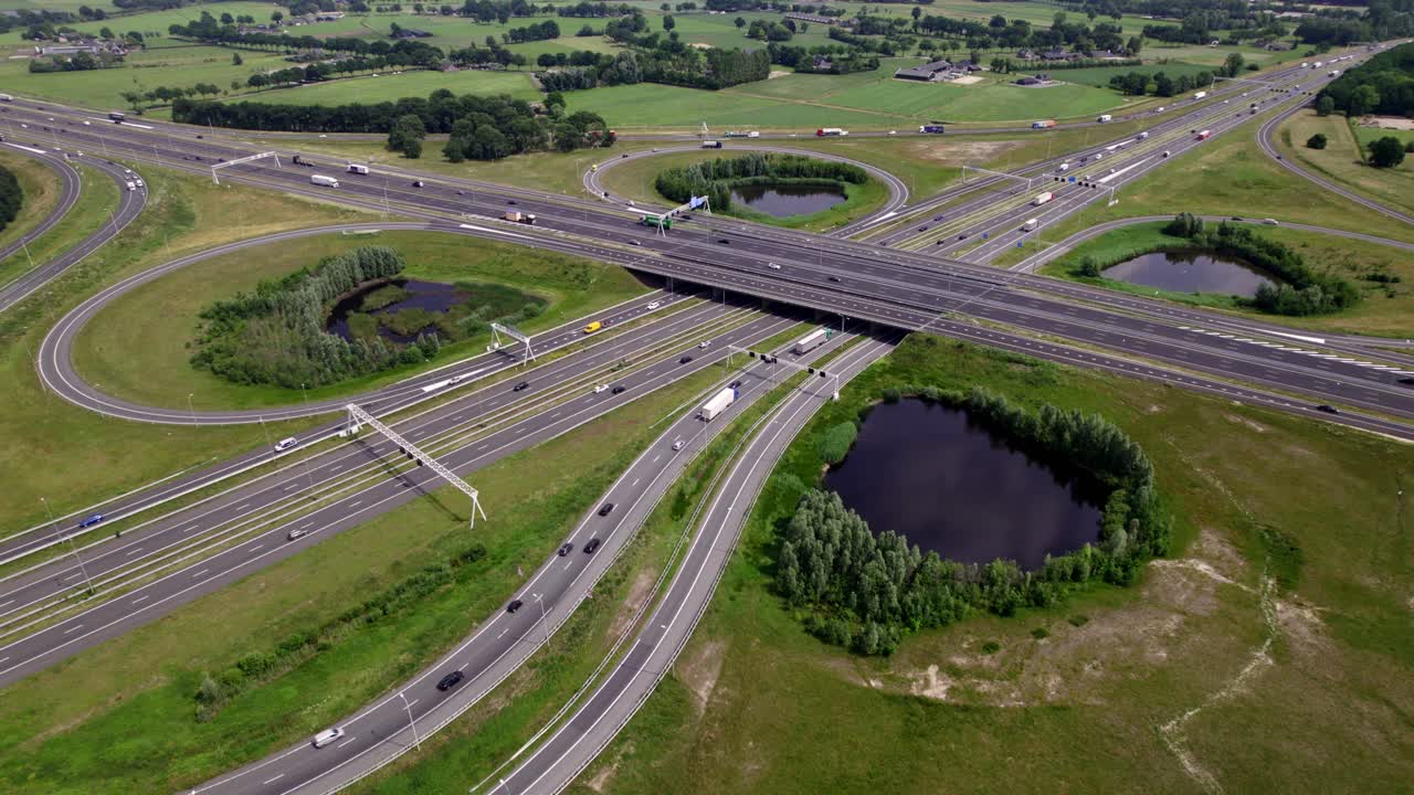 Fixed steady aerial view of freeway junction Voorst near Apeldoorn in Dutch landscape with four-leaf clover shape