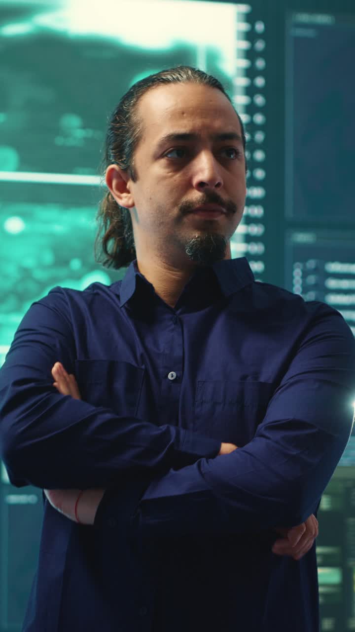 Serious Male Programmer Standing with Crossed Arms in Server Room