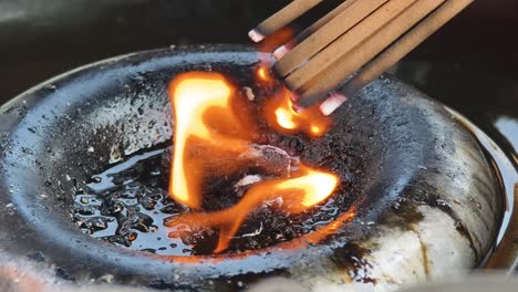 burning incense at a temple