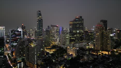 Contaminación-Lumínica-Brillante-Ciudad-Ocupada-Iluminada-Por-La-Noche,-Vista-De-Drones-De-La-Ciudad-De-Bangkok-Por-La-Noche,-Imágenes-Cinematográficas-De-Drones-Aéreos