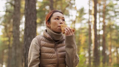 woman enjoying nature in a forest during autumn