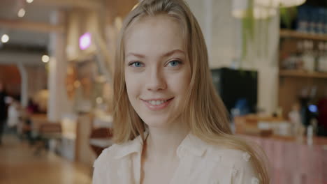woman smiling in a cafe