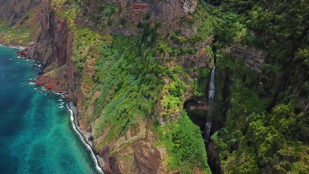 A breathtaking waterfall nestled within dense greenery and rugged cliffs at Miradouro da Quinta do Furão, Madeira, highlighting the island’s rich natural landscapes and serene environment