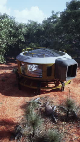 round sci-fi house in desert forest landscape