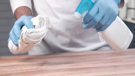 cleaning a wooden table with disinfectant