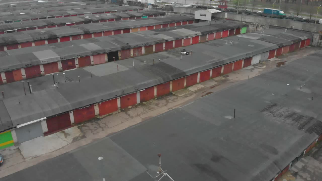 Bird eye from the top view of old red metal door car garage area outside the city