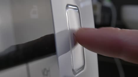 pressing play pause button on the device multiple times close-up