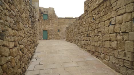 fortress of cittadella with walls made from limestones and path leading to old house