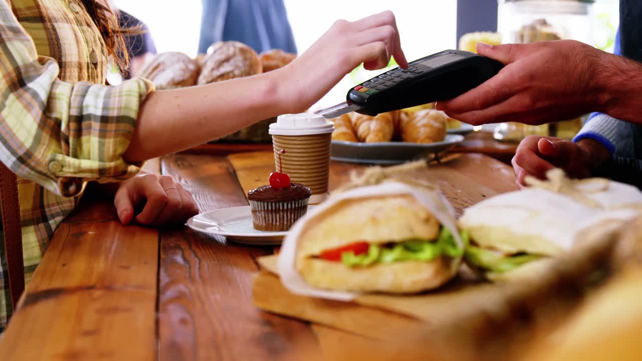 고객이 카운터에서 결제 터미널 머신을 통해 결제를 하는 것