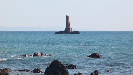 view from the beach of the karori rock lighthouse on the wellington south coast, new zealand