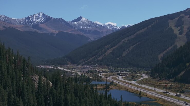 Copper Mountain Leadville Colorado aerial cinematic drone early fall yellow aspen trees colors afternoon Keystone Breckenridge Silverthorne Vail Ten Mile Range blue sky downward motion