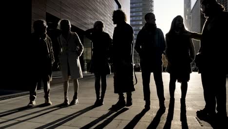 group of businesspeople at sunset in financial district