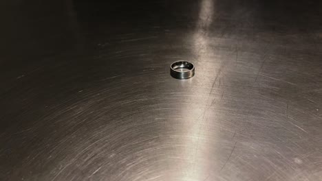 Wedding-Ring-Off-Sliding-Across-Countertop-Close-Up,-Divorce-Scene