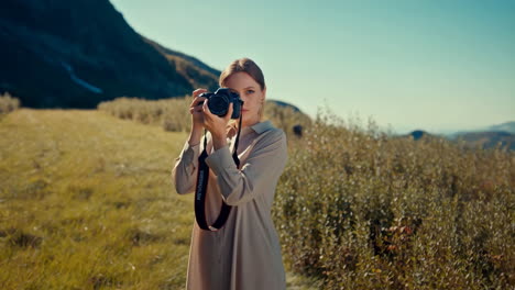 woman taking photo in landscape
