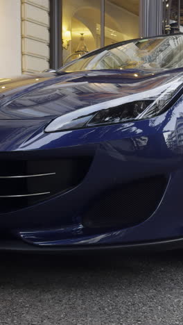 front detail of a dark blue luxury sports car
