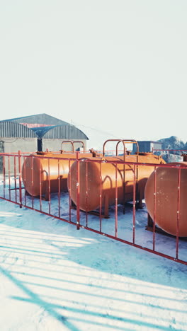 three orange tanks in the snow