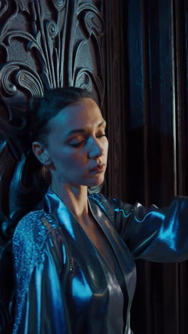 woman in vintage blue silk robe by ornamental door