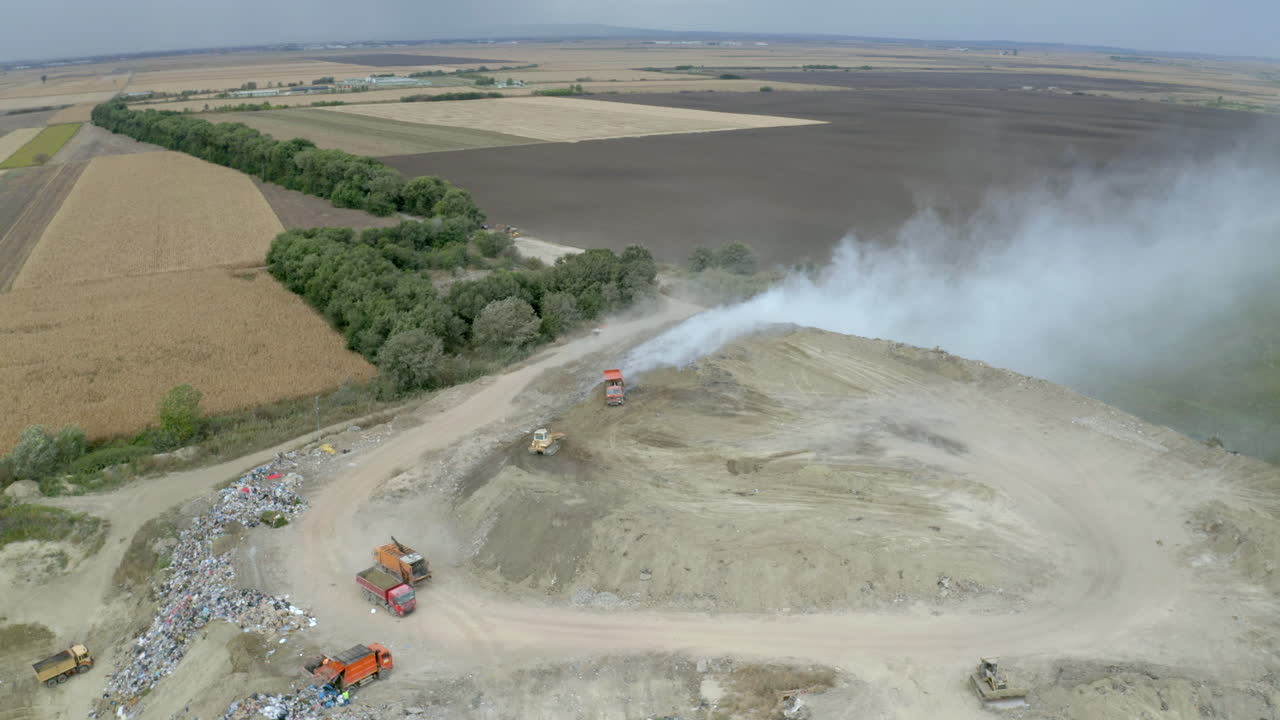 Aerial view of a landfill with trucks and machinery